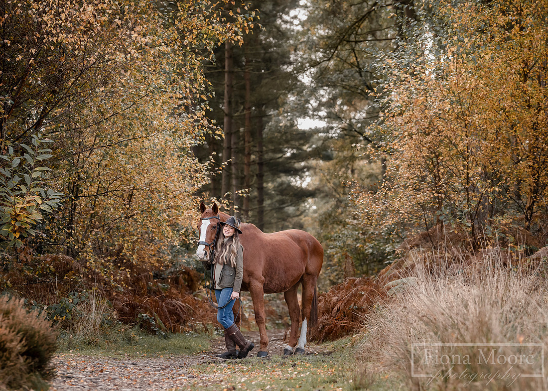 Portrait of a chestnut horse with a young lady in cannock chase forrect during autumn time. Photograph taken by specialist Equine Photographer, Fiona Moore Photography